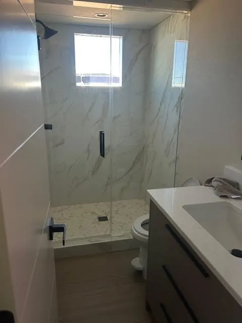 Slide: The Image of Modern bathroom with glass shower, marble walls, and sleek vanity in Adonia Ovation 2023 model. - 15
