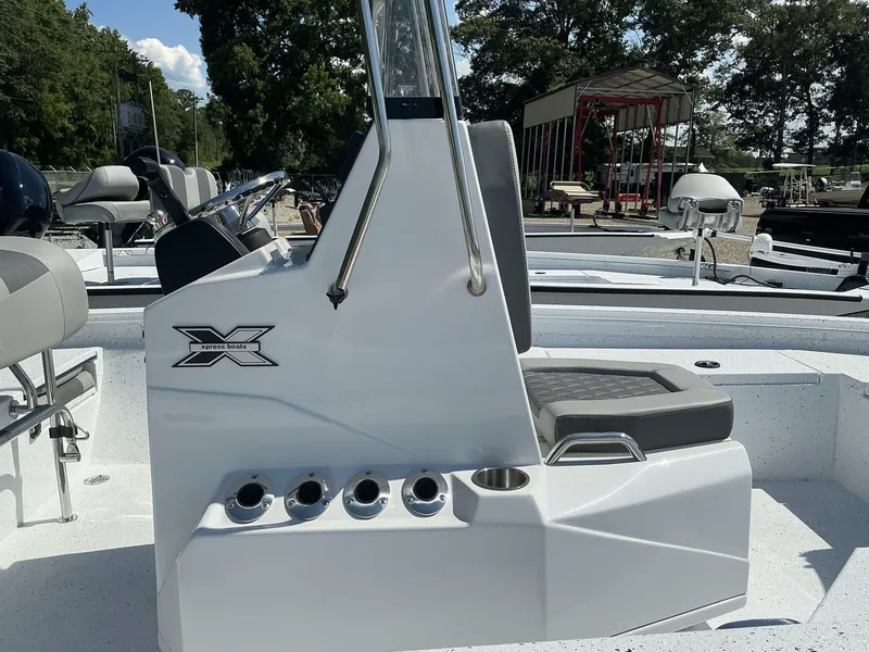Slide: The Image of 2025 Xpress H20B NEW CONSOLE boat with seating and steering wheel. - 5