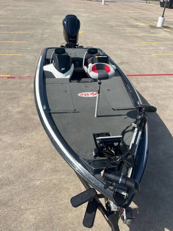 Slide: The Image of 2016 Skeeter ZX 250 bass fishing boat in a parking lot. - 11