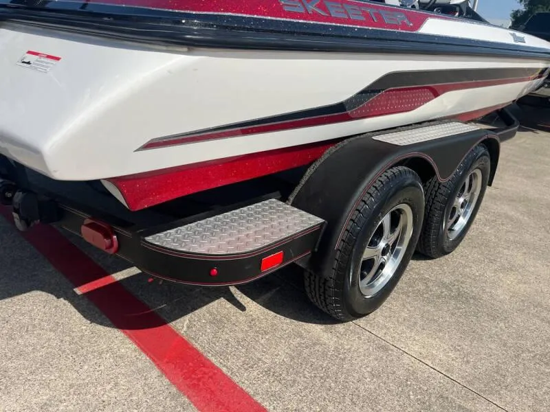 Slide: The Image of 2016 Skeeter ZX 250 boat trailer with dual wheels and step platform. - 18