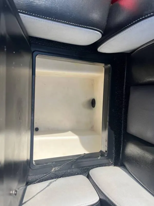 Slide: The Image of 2016 Skeeter ZX 250 boat storage compartment with black and white interior. - 28