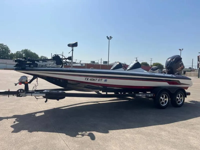 Slide: The Image of 2016 Skeeter ZX 250 bass boat on trailer in parking lot. - 36