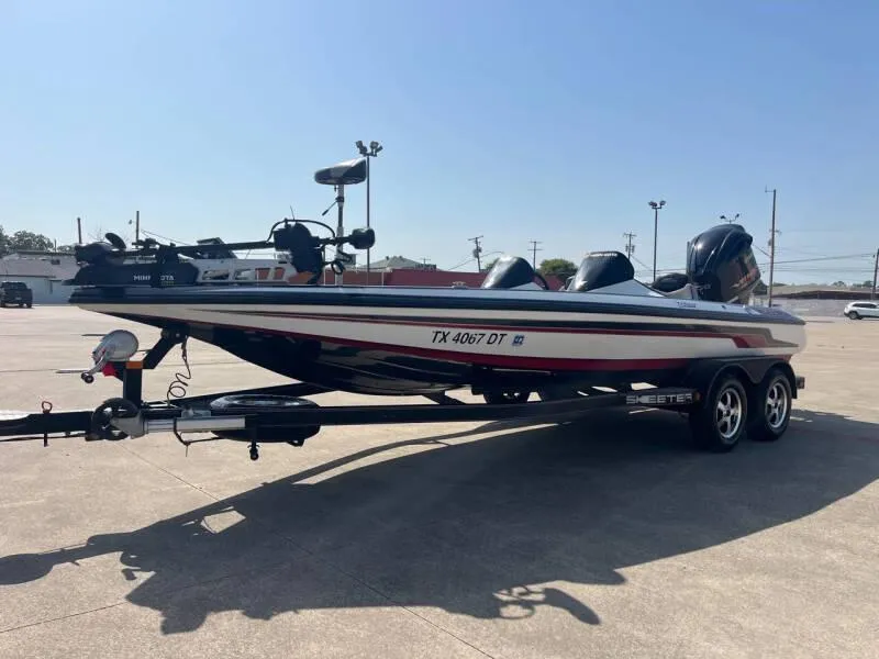 Slide: The Image of 2016 Skeeter ZX 250 bass boat on trailer in parking lot. - 5