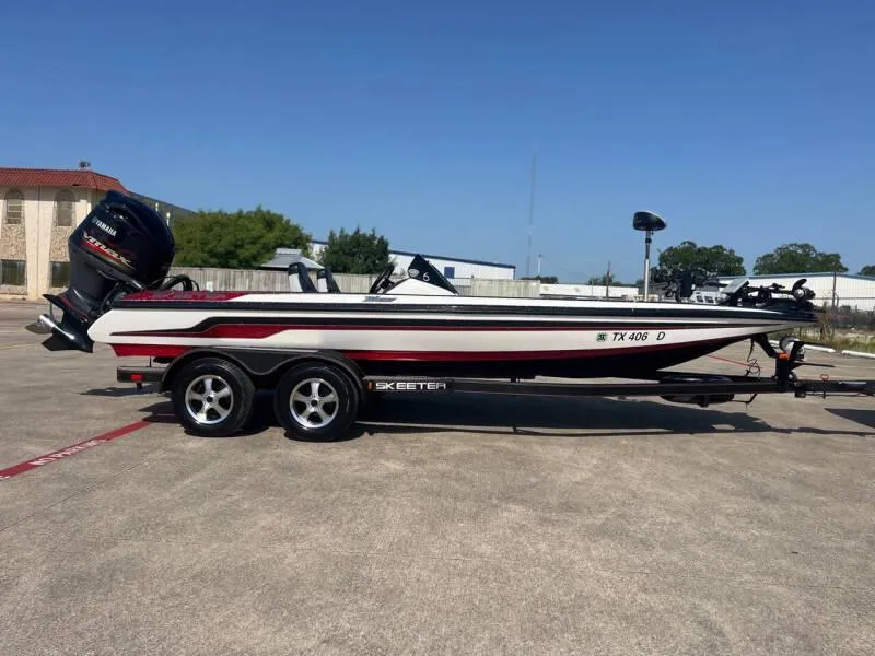 Slide: The Image of 2016 Skeeter ZX 250 boat on a trailer in a parking lot. - 52