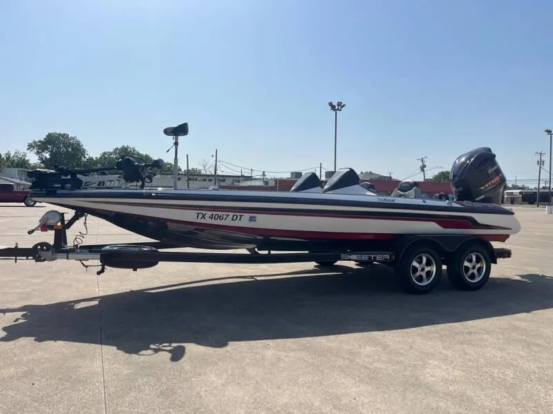 Slide: The Image of 2016 Skeeter ZX 250 bass boat on trailer in parking lot. - 53