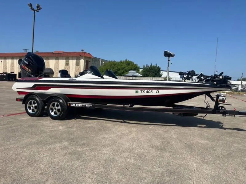 Slide: The Image of 2016 Skeeter ZX 250 bass boat on trailer in parking lot. - 9