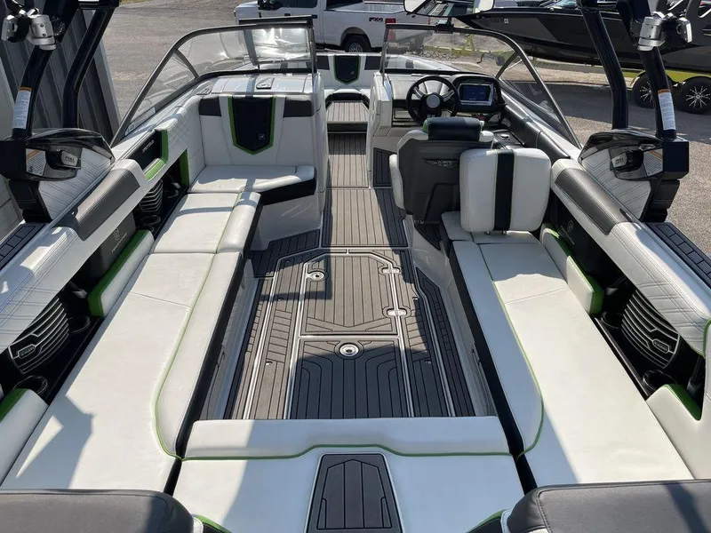 Slide: The Image of 2016 Nautique G25 boat interior with spacious seating and modern dashboard. - 6
