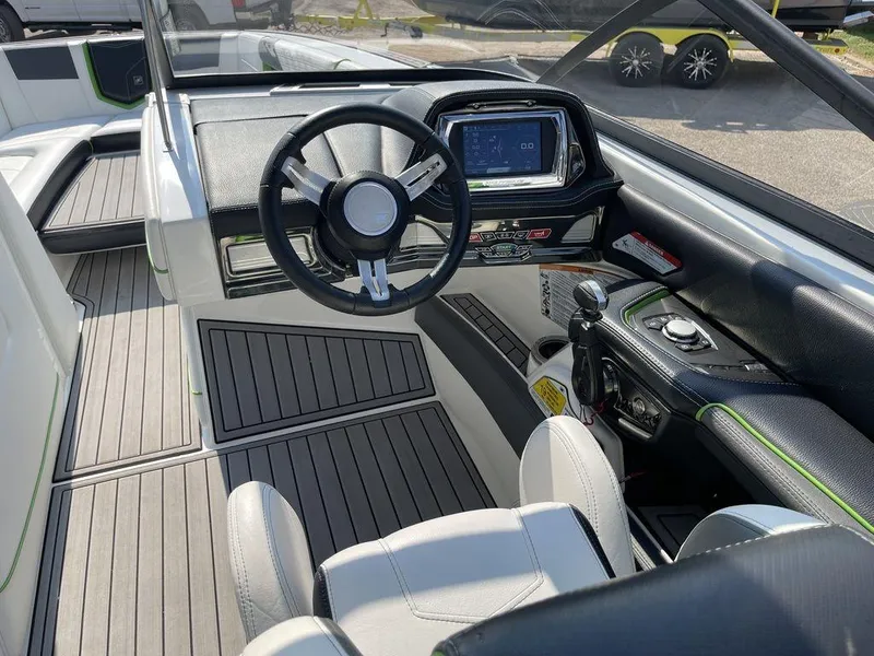 Slide: The Image of 2016 Nautique G25 boat interior with steering wheel and control panel. - 7
