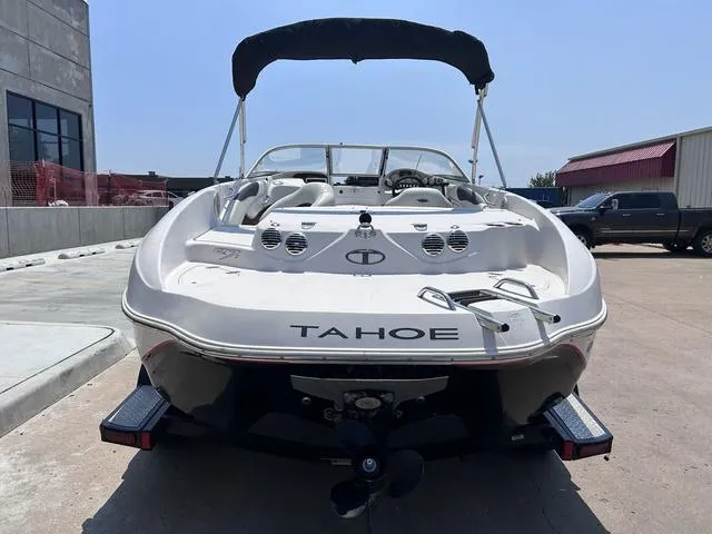 Slide: The Image of 2015 Tahoe Q7i boat rear view with bimini top in a parking lot. - 3