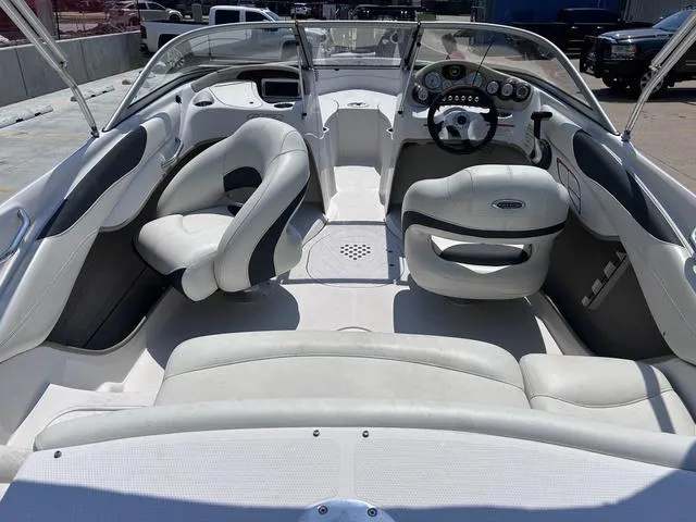 Slide: The Image of 2015 Tahoe Q7i boat interior with white and gray seating, steering wheel, and dashboard. - 4