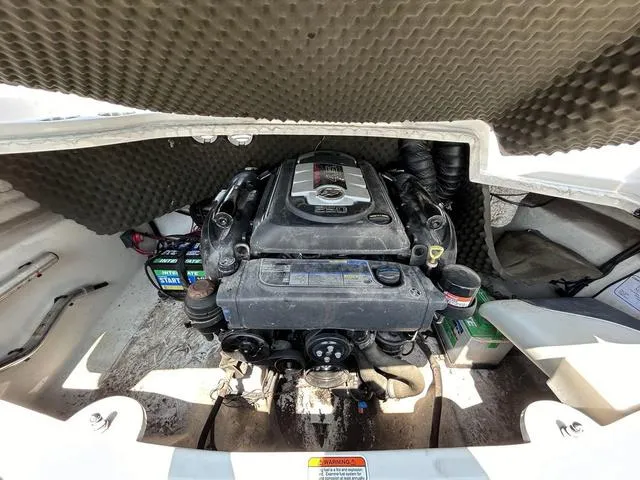 Slide: The Image of 2015 Tahoe Q7i boat engine compartment with visible engine and components. - 9