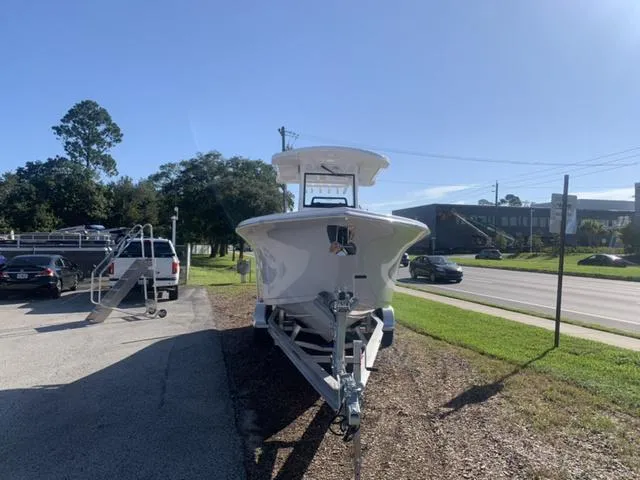Slide: The Image of 2024 Sea Pro 262 CC boat on trailer in parking lot, sunny day. - 10