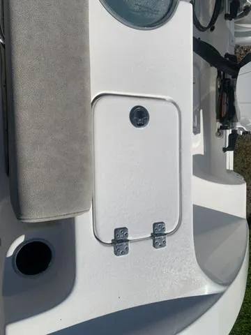 Slide: The Image of 2024 Sea Pro 262 CC boat detail, featuring a white hatch with hinges and a cushioned seat. - 14