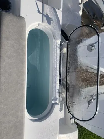 Slide: The Image of 2024 Sea Pro 262 CC boat livewell with open lid, showcasing interior water. - 15