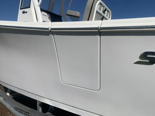 Slide: The Image of 2024 Sea Pro 262 CC boat side view, featuring sleek white design and logo. - 18