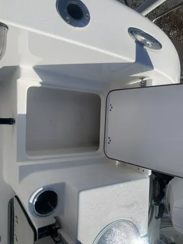 Slide: The Image of 2024 Sea Pro 262 CC boat interior storage compartment with open hatch. - 21