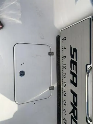 Slide: The Image of 2024 Sea Pro 262 CC boat deck with hatch and measuring scale. - 22