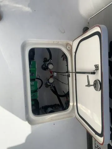 Slide: The Image of 2024 Sea Pro 262 CC boat compartment with visible wiring and components. - 23