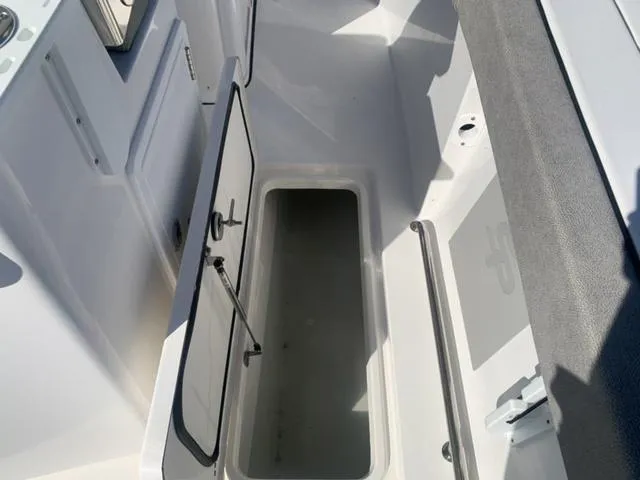 Slide: The Image of 2024 Sea Pro 262 CC boat storage compartment open, showcasing interior space. - 29