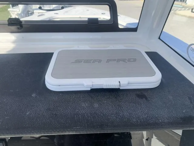 Slide: The Image of 2024 Sea Pro 262 CC boat dashboard with Sea Pro logo panel. - 37