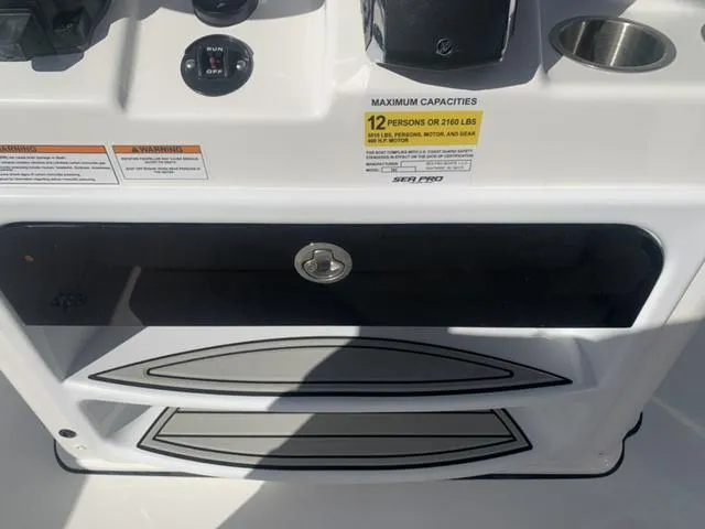 Slide: The Image of 2024 Sea Pro 262 CC boat console with capacity label for 12 persons or 2160 lbs. - 38