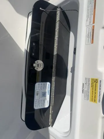 Slide: The Image of 2024 Sea Pro 262 CC boat compartment with capacity label and safety instructions. - 39