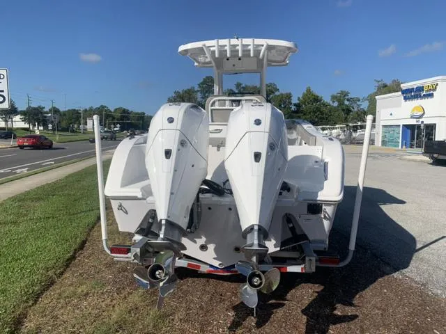 Slide: The Image of 2024 Sea Pro 262 CC boat with dual outboard engines, parked on a sunny day. - 4
