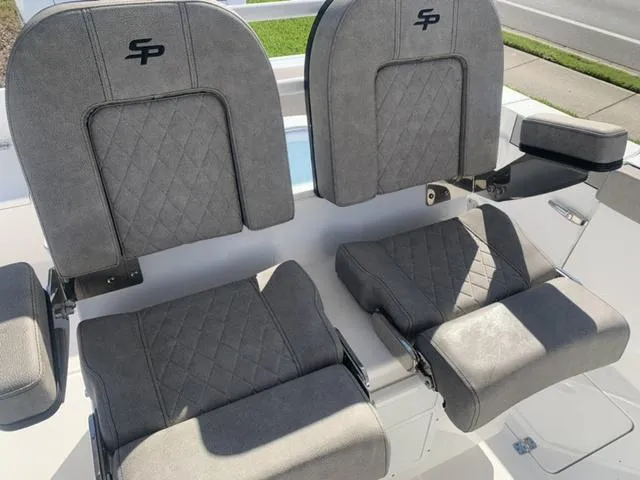 Slide: The Image of 2024 Sea Pro 262 CC boat seats with gray upholstery and diamond stitching. - 42