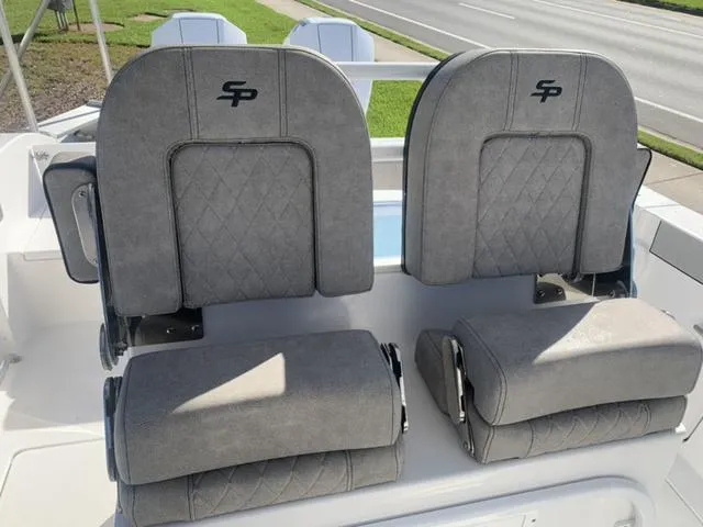 Slide: The Image of 2024 Sea Pro 262 CC boat seats with gray upholstery and SP logo. - 43