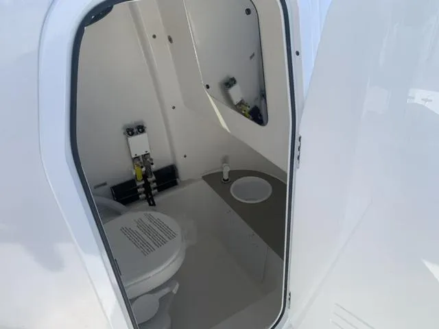 Slide: The Image of 2024 Sea Pro 262 CC boat interior with compact bathroom and toilet. - 44