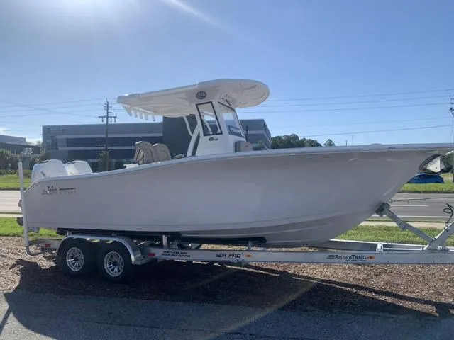 Slide: The Image of 2024 Sea Pro 262 CC boat on trailer, side view, sunny day. - 6