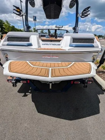 Slide: The Image of 2023 Nautique Super Air Nautique GS20 boat rear view with teak swim platform. - 12