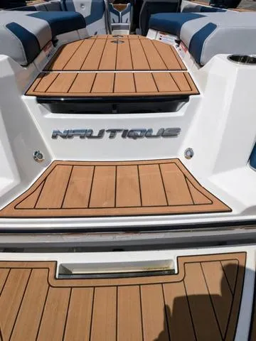 Slide: The Image of 2023 Nautique Super Air Nautique GS20 boat with teak deck and white hull. - 13