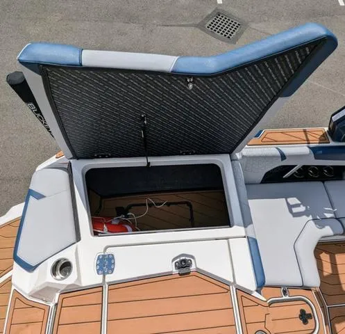 Slide: The Image of 2023 Nautique Super Air Nautique GS20 open storage compartment on deck. - 15