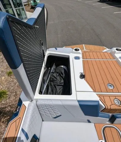 Slide: The Image of 2023 Nautique Super Air Nautique GS20 boat with open storage compartment. - 16