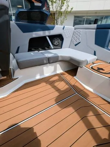 Slide: The Image of 2023 Nautique Super Air Nautique GS20 interior with cushioned seating and teak flooring. - 21