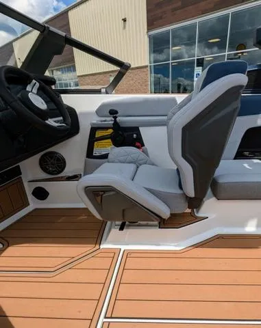 Slide: The Image of 2023 Nautique Super Air Nautique GS20 interior with captain's seat and helm. - 22
