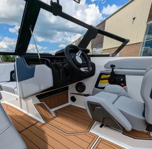 Slide: The Image of 2023 Nautique Super Air Nautique GS20 boat interior with modern helm and seating. - 23