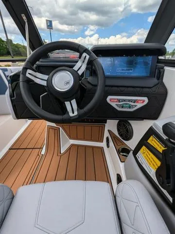 Slide: The Image of 2023 Nautique Super Air Nautique GS20 boat interior with steering wheel and dashboard. - 24