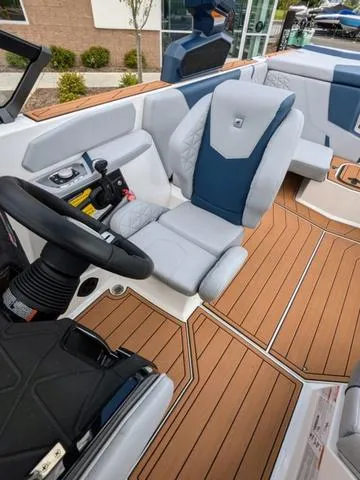 Slide: The Image of 2023 Nautique Super Air Nautique GS20 boat interior with luxurious seating and modern controls. - 27
