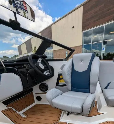 Slide: The Image of 2023 Nautique Super Air Nautique GS20 interior with captain's chair and dashboard. - 28