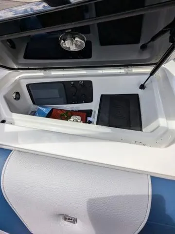 Slide: The Image of 2023 Nautique Super Air Nautique GS20 storage compartment with control panel. - 30