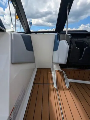 Slide: The Image of 2023 Nautique Super Air Nautique GS20 interior with teak flooring and modern design. - 35