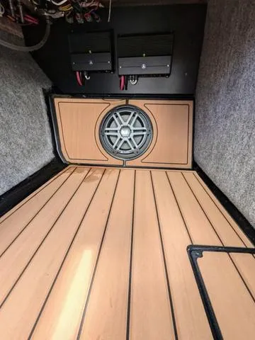 Slide: The Image of 2023 Nautique Super Air Nautique GS20 interior with speaker and wooden flooring. - 36