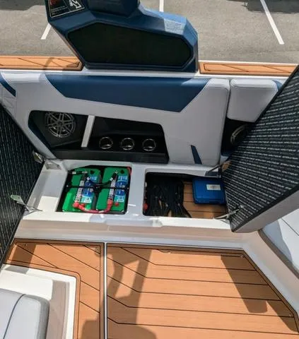 Slide: The Image of 2023 Nautique Super Air Nautique GS20 storage compartment with batteries and wiring. - 38