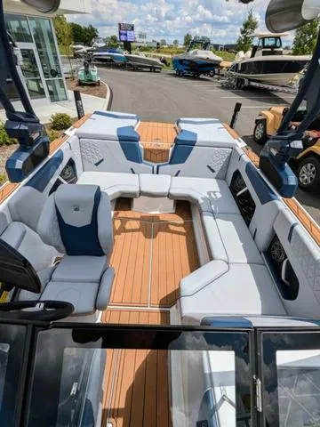 Slide: The Image of 2023 Nautique Super Air Nautique GS20 boat interior with luxurious seating and teak flooring. - 40
