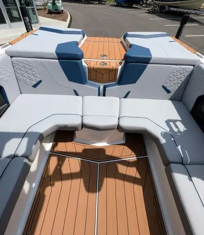Slide: The Image of 2023 Nautique Super Air Nautique GS20 boat interior with cushioned seating and teak flooring. - 48