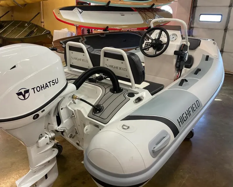 Slide: The Image of 2024 Highfield Sport 360 inflatable boat with Tohatsu outboard motor in showroom. - 7