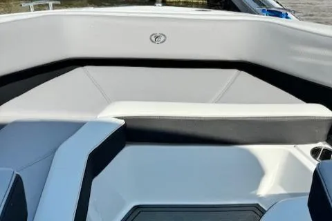 Slide: The Image of 2022 Cobalt R6 Surf boat interior seating area with white and black upholstery. - 13