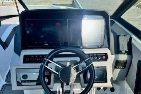 Slide: The Image of 2022 Cobalt R6 Surf boat dashboard with steering wheel and digital displays. - 16